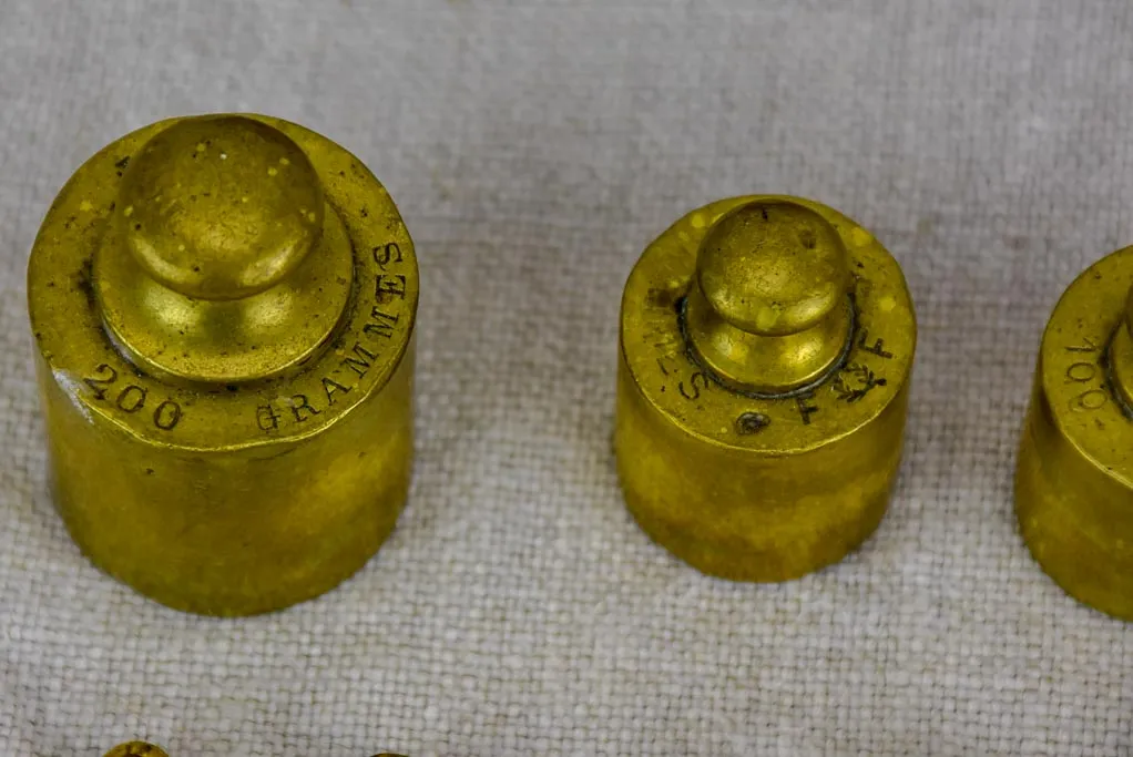 Set of eleven antique French weights for scales - 1-200g